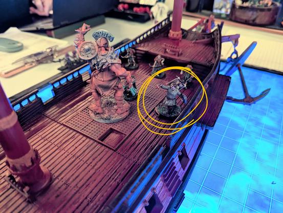 A closer view of the deck of the ship, a large orc is squared off against three party members at a safe distance, with a cleric (circled in yellow) standing next to him, back to the trailing, holding out his holy symbol.