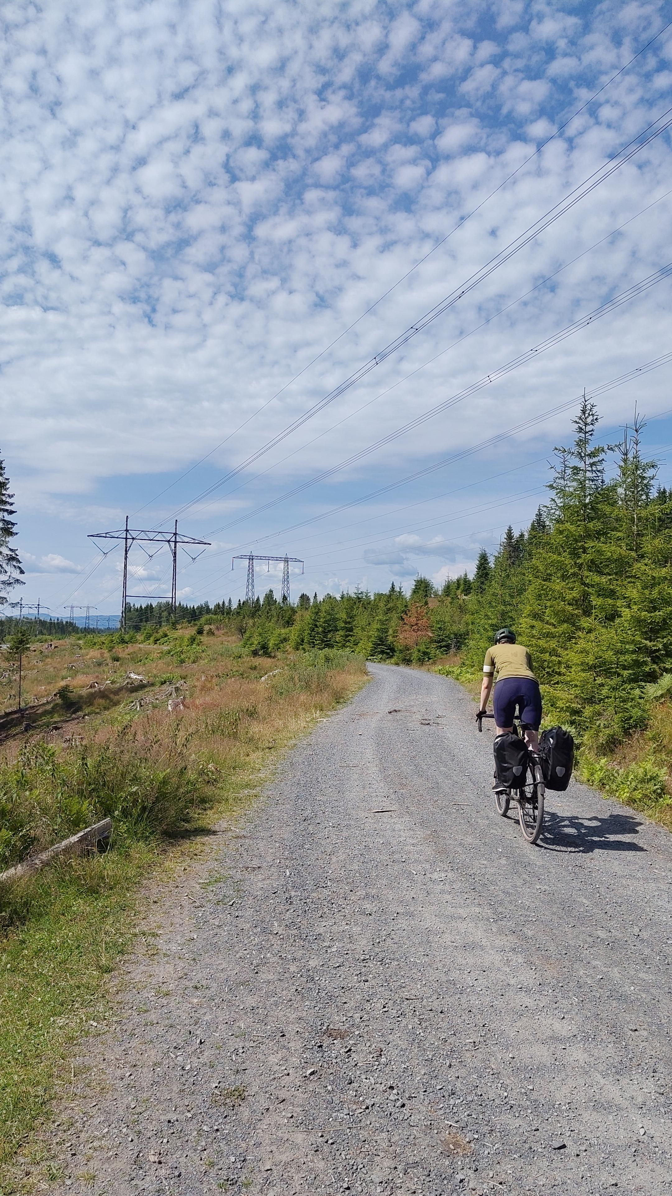 Cyclist on gravel road.
