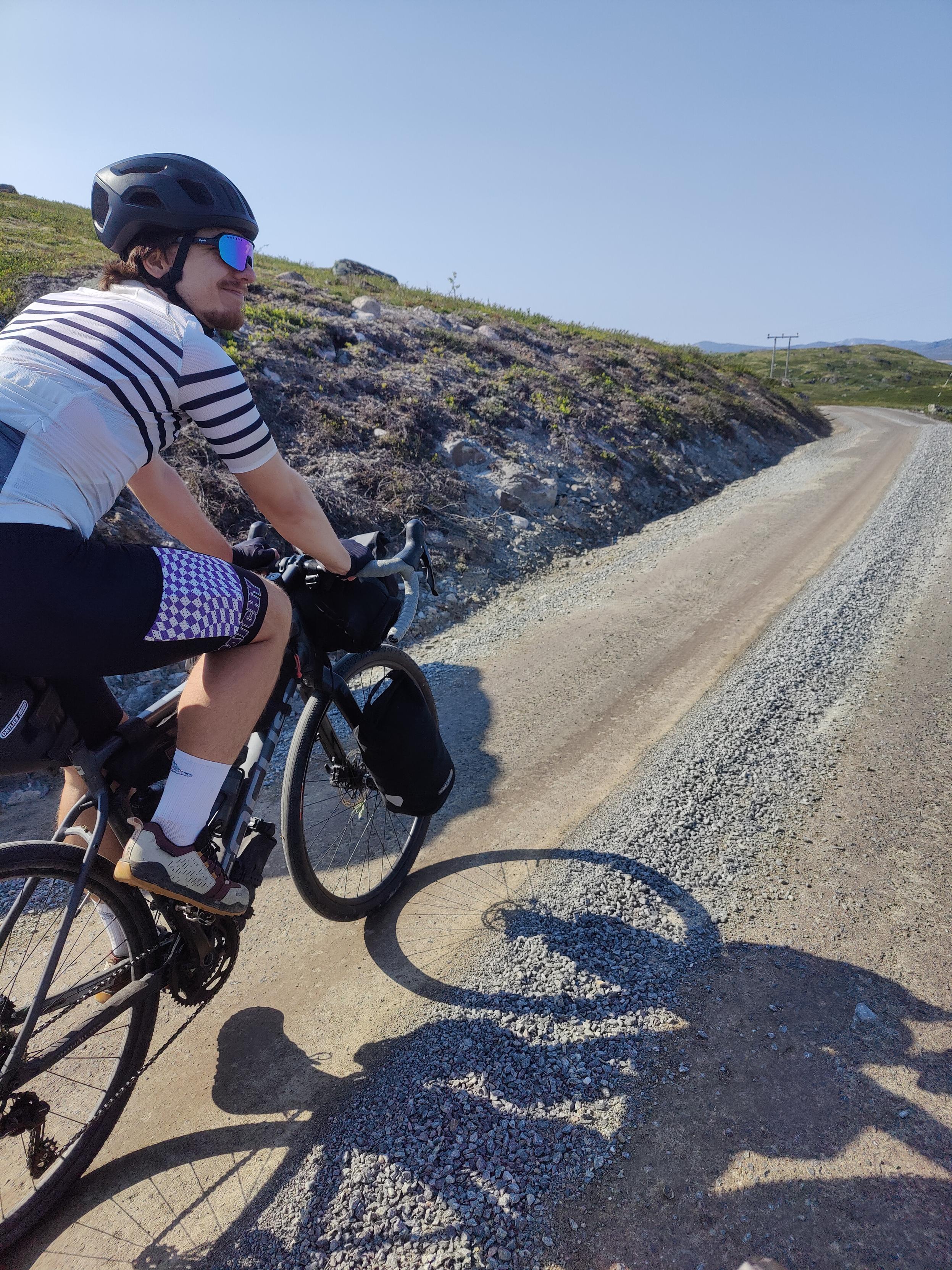 Cyclist on gravel road.