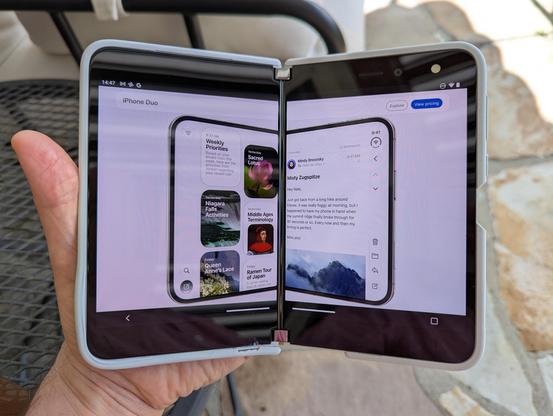 A foldable phone with a web page loaded that shows a foldable phone, opened in the same way the containing phone is, so they share a center fold line.